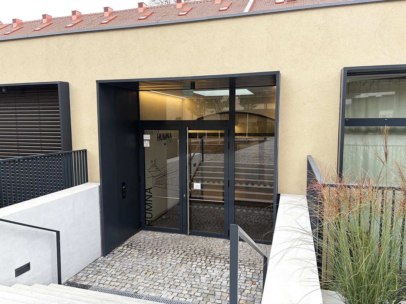 Cross the courtyard to the entrance of the Humna building. Hold the same chip to